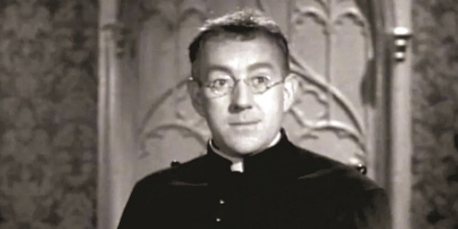 GUINNES vestido como sacerdote